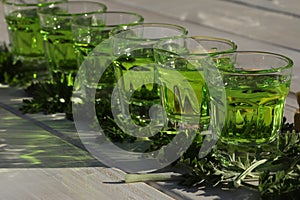 Green absinthe drink on the white background