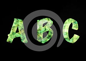 Green abstract ABC alphabet letters on black background