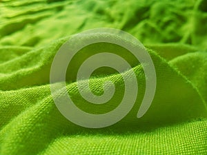 Green abstract background bumps of corrugated cotton fabric.