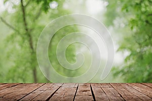 Green abstract blur nature background with wooden floor