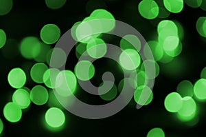 Green abstract Christmas blurred luminous background. Defocused artistic bokeh lights image