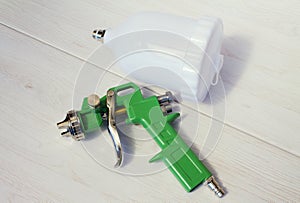 Green air compressor gun. Isolated on a wooden background