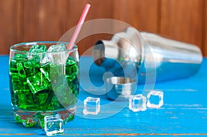 Green alcohol or alcohol-free cocktail with straw