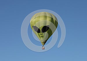 Green Alien Hot Air Balloon Against a Blue Sky