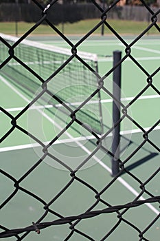 Green All Weather Tennis Court view through fence