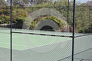 Green All Weather Tennis Court view through fence