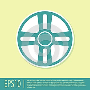 Green Alloy wheel for a car icon isolated on yellow background. Vector