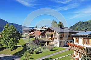 Green alpine meadows and chalets.