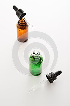 Green, amber mini bottles mockups with pipettes.