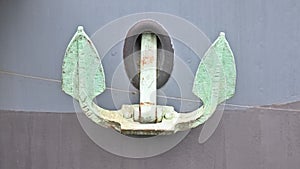 Green anchor on a black ship