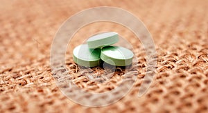 green antidepressant pills on small jute bag background photo
