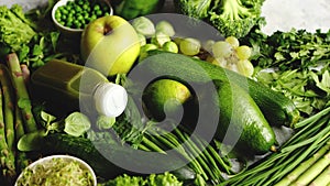 Green antioxidant organic vegetables, fruits and herbs placed on gray stone