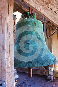 Green antique big bell in a village chapel. Beautiful Christian architecture, religion and traditions. Croatia, the city of Zadar