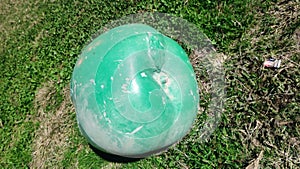 green apple art object on the grass