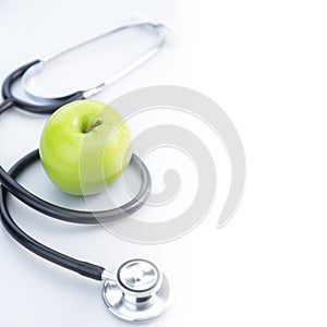 Green Apple with Black Stethoscope