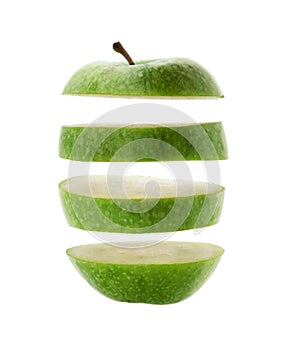 Green apple cut into slices isolated over a white