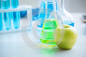 Green Apple in food science lab for high antioxidant bio flavonoid vitamin C nutrition healthcare extraction from fruit