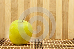 Green apple in front the wooden background