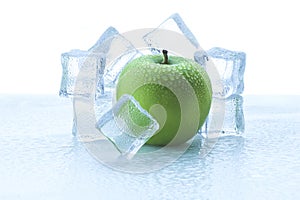 green apple on ice cubes with water droplets on white background