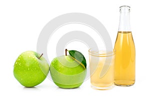 glass of apple cider vinegar and green granny smith apples isolated on white .