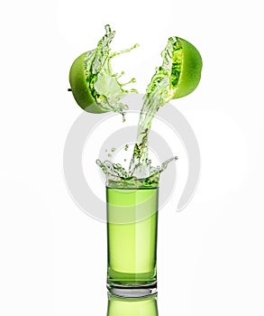 Green apple juice splashing with its fruits