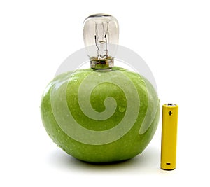 Green apple with a lamp and a battery