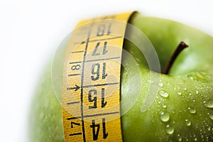 Green apple with measure tape