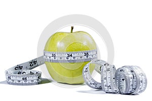 Green apple and measurement tape