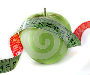 Green apple with measuring tape