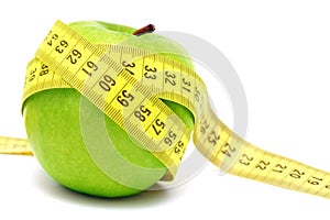 Green apple and measuring tape