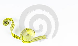 Green apple and measuring tape. Diet concept