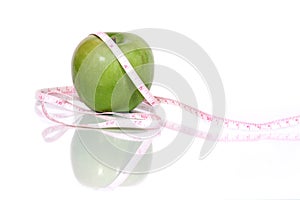 Green apple and measurment tape
