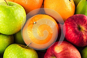 Green apple and orange and red apple and banana are mixed tasty fruit composition on  background fruit health food