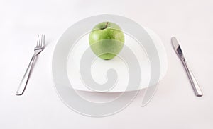 Green apple on a plate