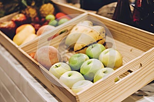 Green apple, Red apple and Various types of fruit in wooden box.