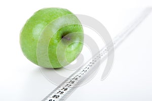 Green apple with a ruler