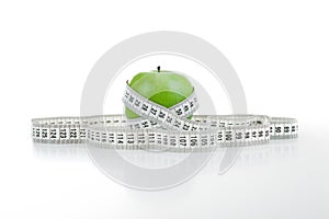 Green apple with a ruler