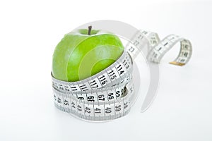 Green apple with a ruler