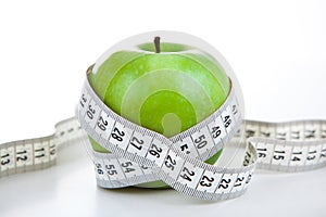 Green apple with a ruler