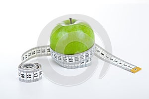 Green apple with a ruler