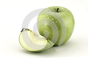 Green apple and a slice of apple on white background