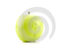 Green apple with stapled crack