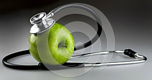 Green Apple with Stethoscope on Gray Background