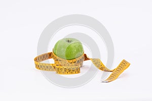 Green apple with tape measure