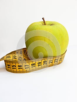 Green apple with tape measure