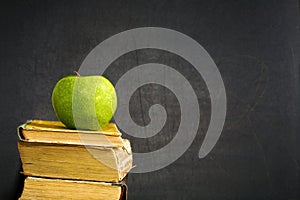 Green apple on textbook