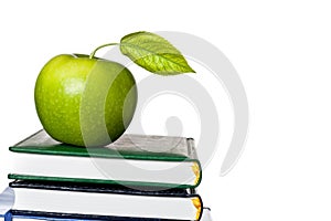 Green apple on textbook isolated