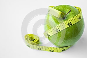 Green apple with waist and measuring tape