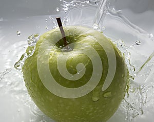 Green apple in water