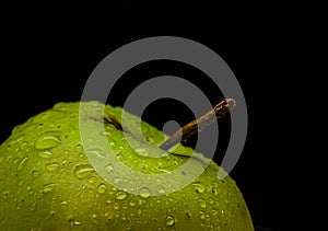 Green apple with water droplets